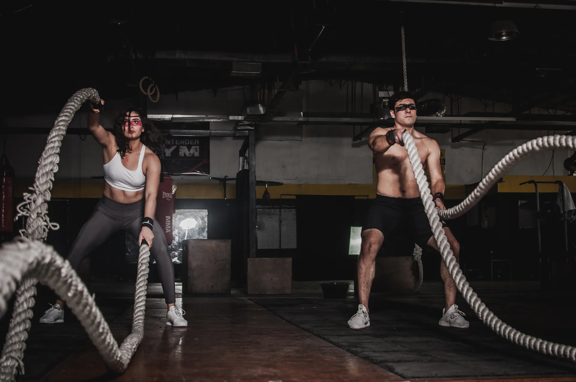 Athlete training intensely in a modern gym with dramatic lighting
