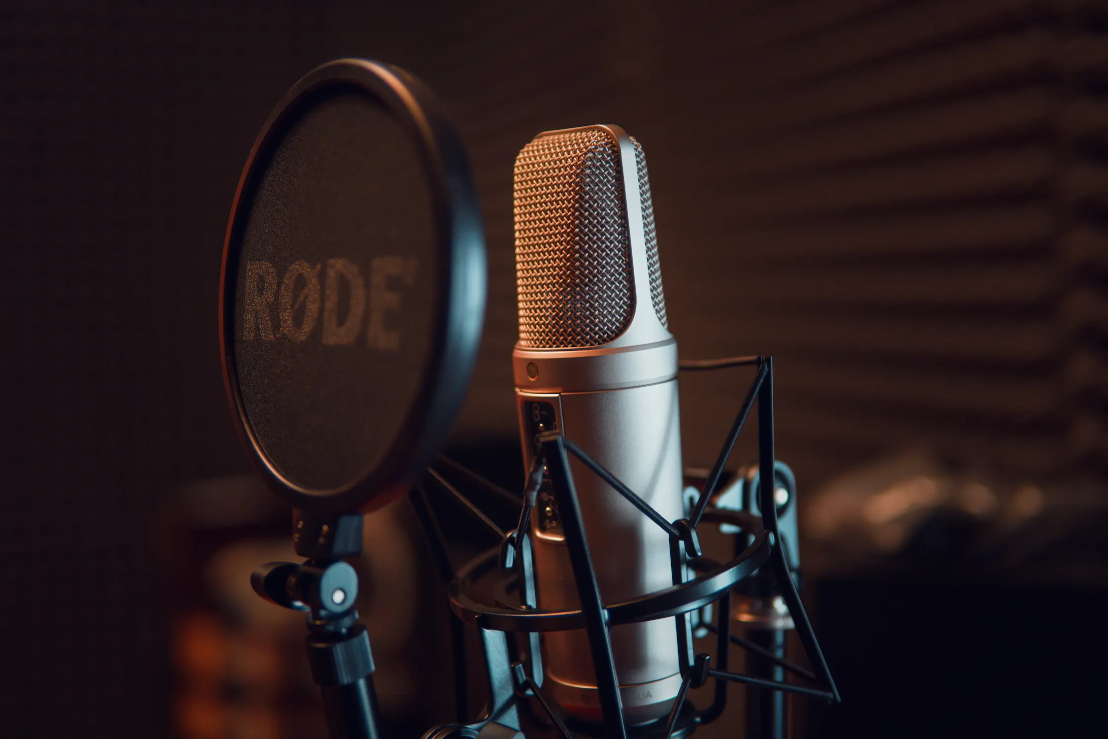 Professional podcast recording studio with microphones and mixing equipment.