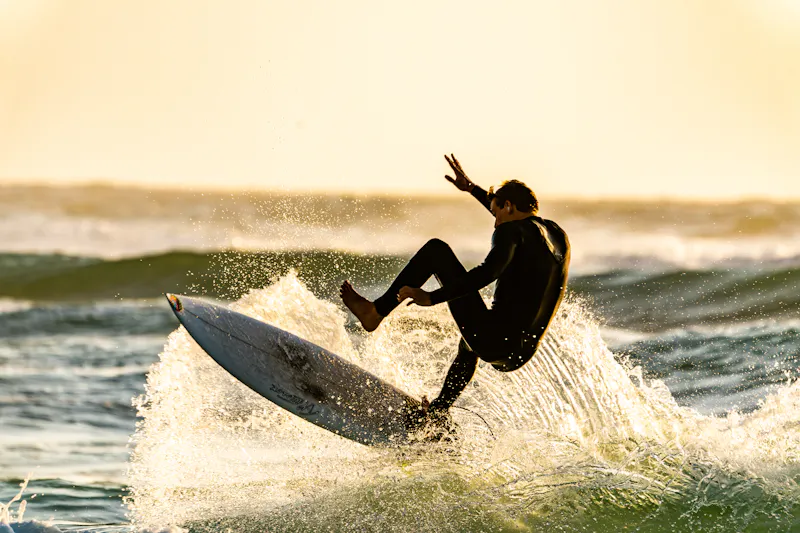 Surf instructor teaching student in the ocean